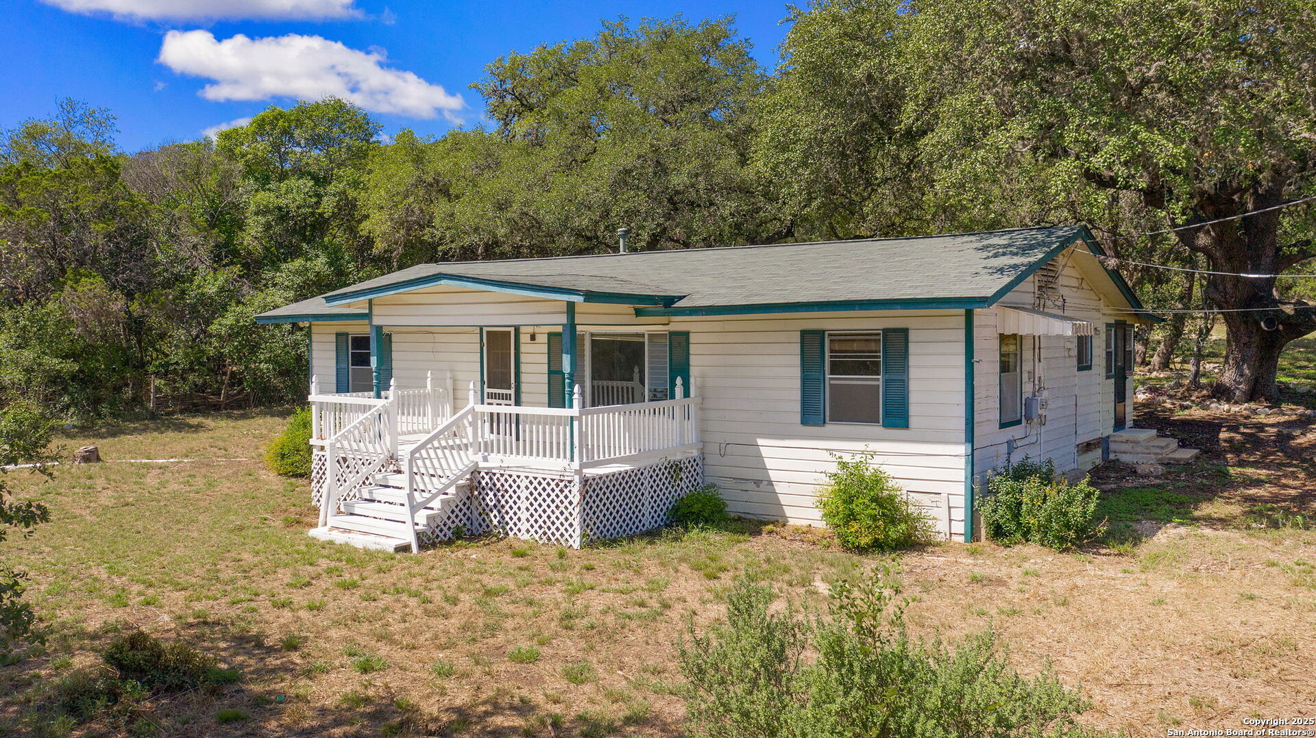 10096 Whip O Will Way Helotes, TX 78023 - Photo 18 of 39 a front view of a house with a garden