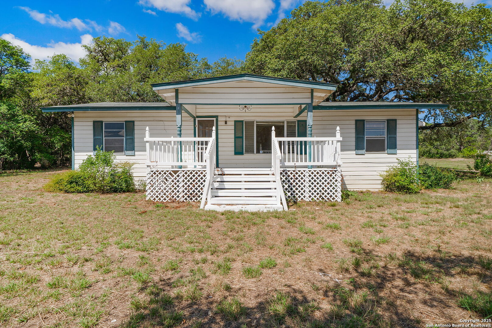 10096 Whip O Will Way Helotes, TX 78023 - Photo 21 of 39 a front view of a house with a garden