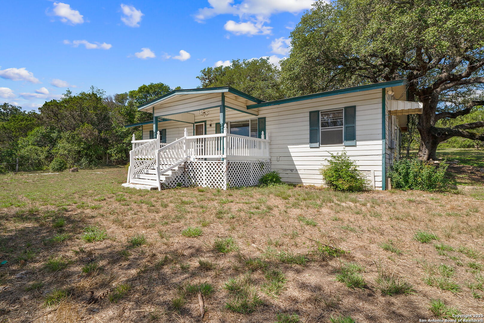 10096 Whip O Will Way Helotes, TX 78023 - Photo 22 of 39 a front view of a house with a yard and garage
