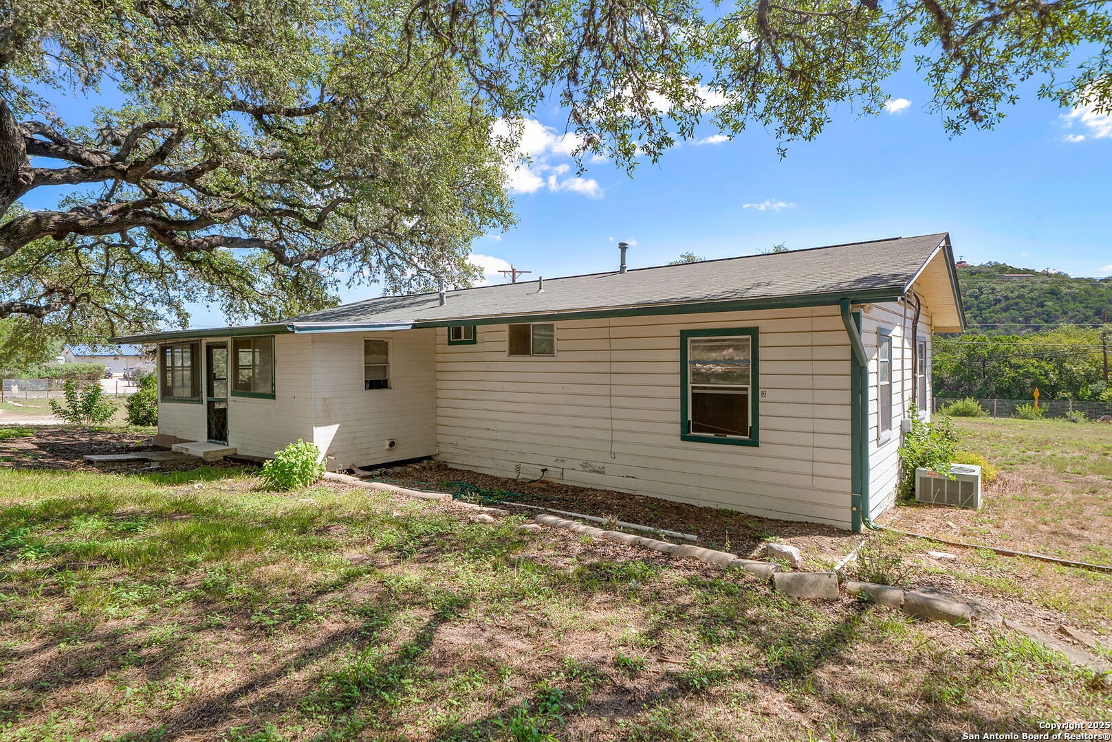 10096 Whip O Will Way Helotes, TX 78023 - Photo 24 of 39 a view of backyard of house with green space