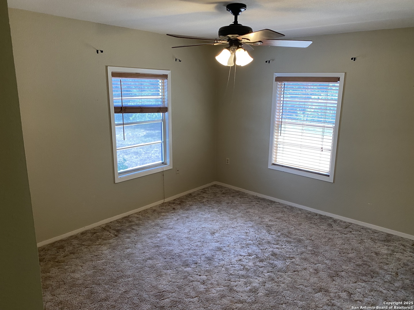 10096 Whip O Will Way Helotes, TX 78023 - Photo 33 of 39 an empty room with windows and fan
