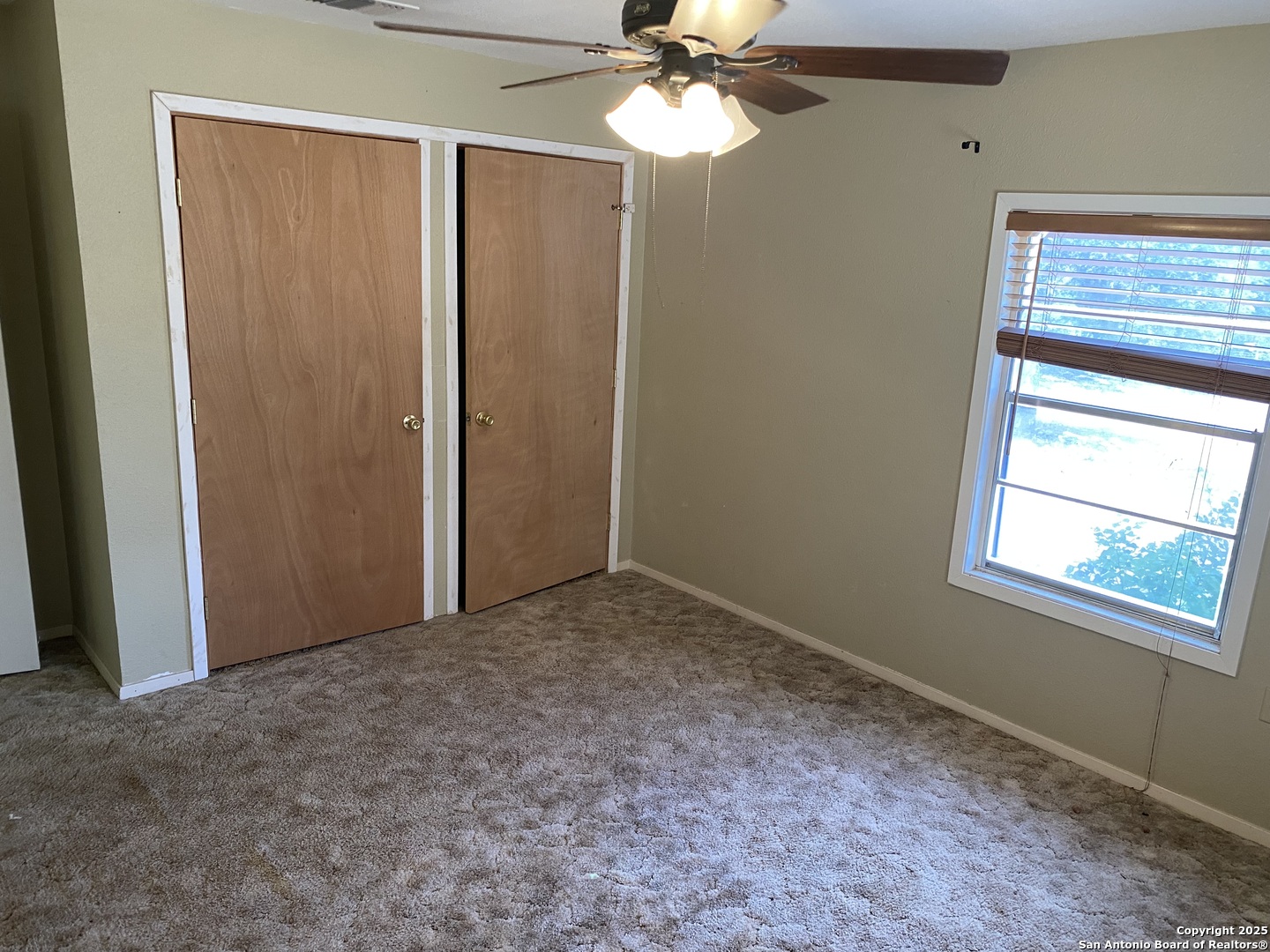 10096 Whip O Will Way Helotes, TX 78023 - Photo 34 of 39 an empty room with a window and a fan