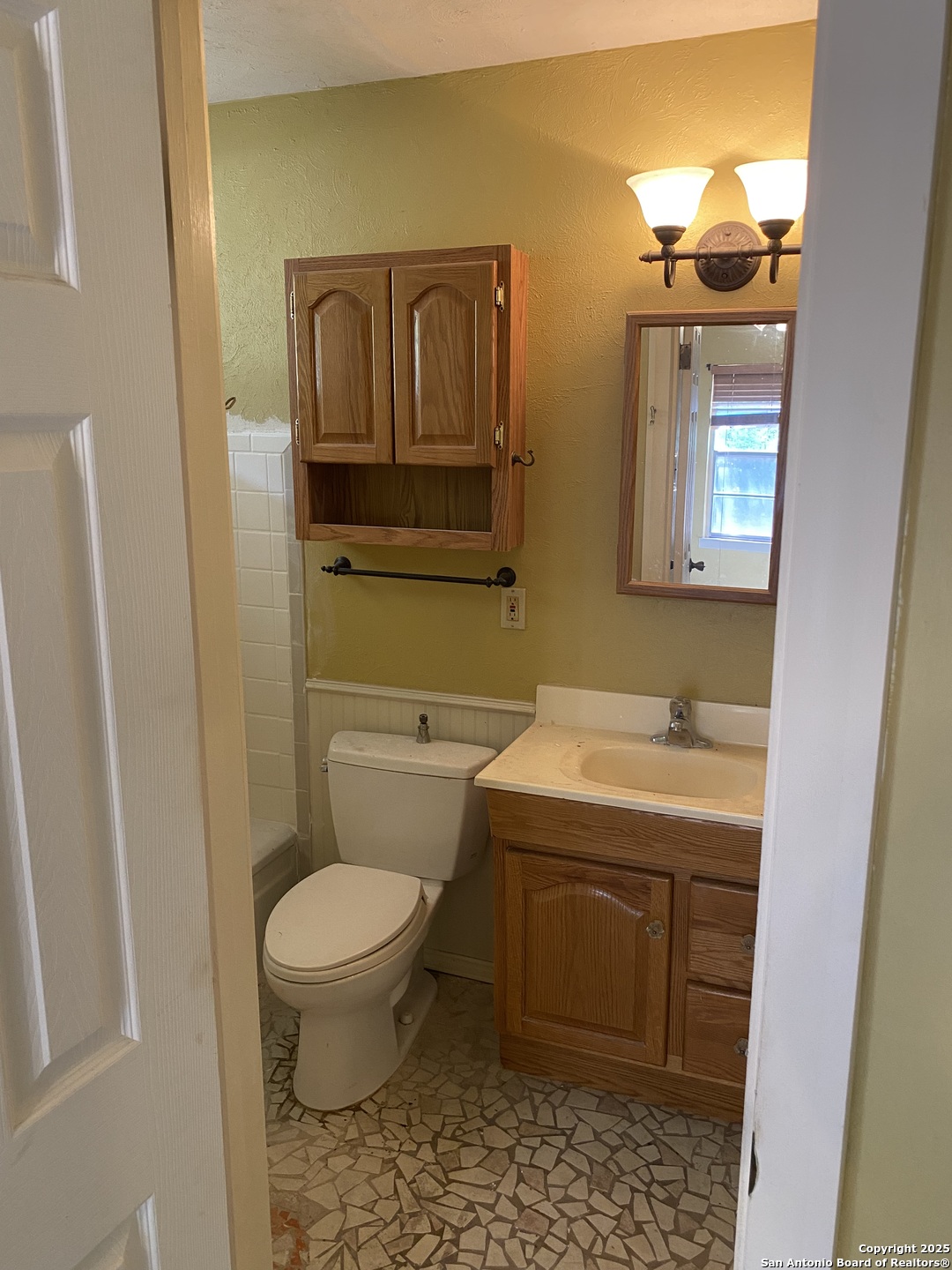 10096 Whip O Will Way Helotes, TX 78023 - Photo 36 of 39 a bathroom with a toilet sink and mirror