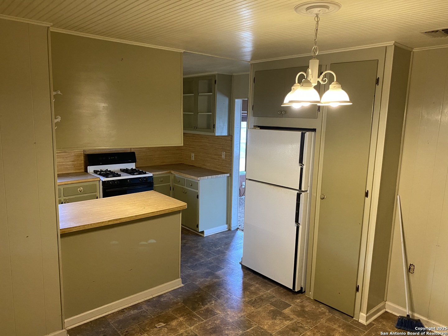 10096 Whip O Will Way Helotes, TX 78023 - Photo 39 of 39 a kitchen with a refrigerator a stove and a wooden floor