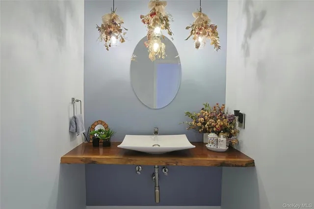 a bathroom with a sink mirror and vanity