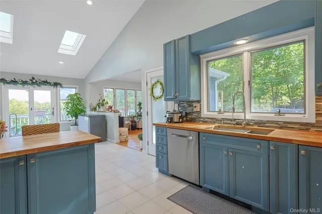 a kitchen with large windows and cabinets