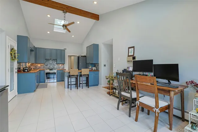 a workspace with kitchen island granite countertop furniture and a flat screen tv