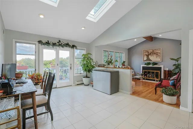 a dining room with furniture and a floor to ceiling window