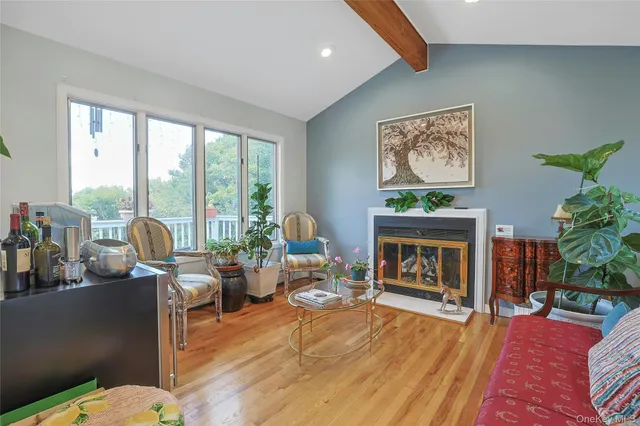 a living room with furniture large window and a fireplace