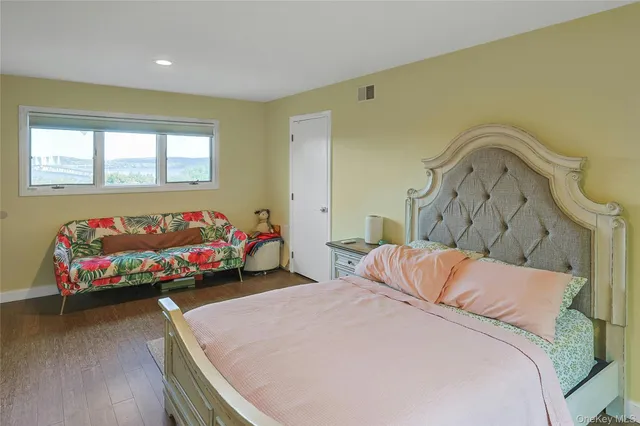 a bedroom with a bed and a couch