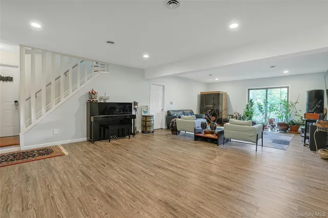 a view of a livingroom with furniture and a flat screen tv