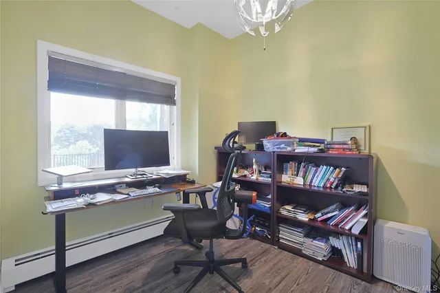 a work room with furniture and a flat screen tv