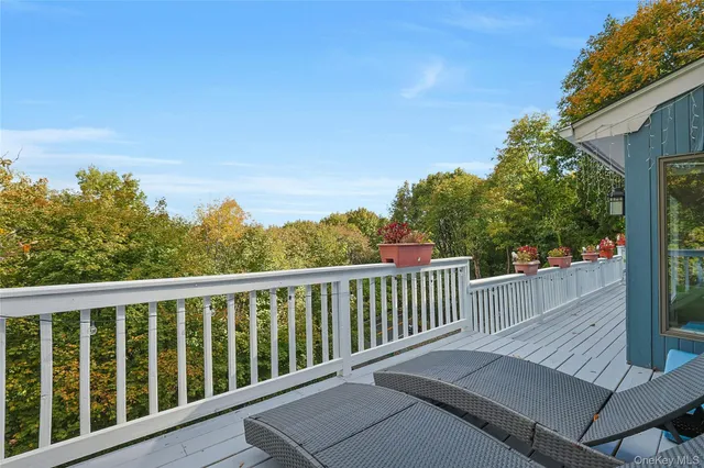 a view of a balcony with wooden floor and fence