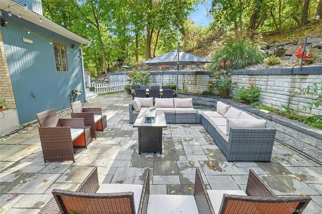 a view of backyard of house with seating space