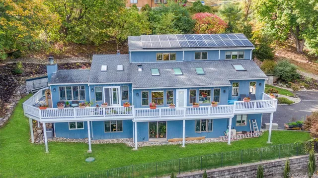 a view of a house with a deck and a yard