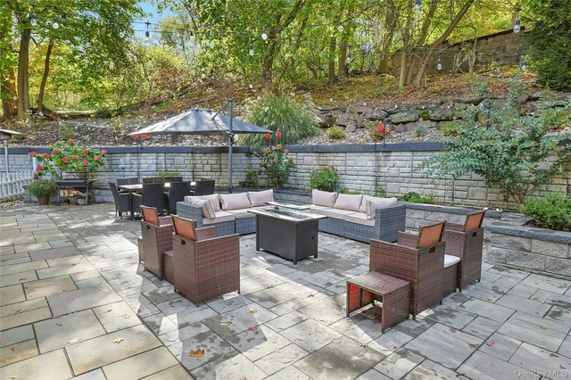 a view of a roof deck with furniture