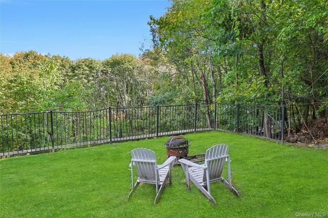 a view of a chair and table on the green field