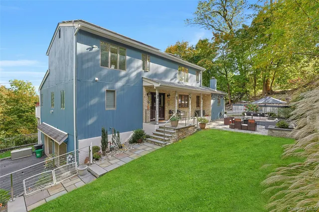 a view of a house with a yard porch and sitting area