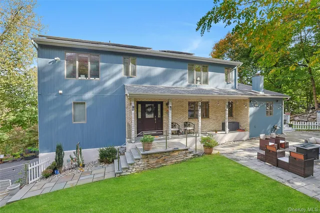 a front view of a house with garden and patio