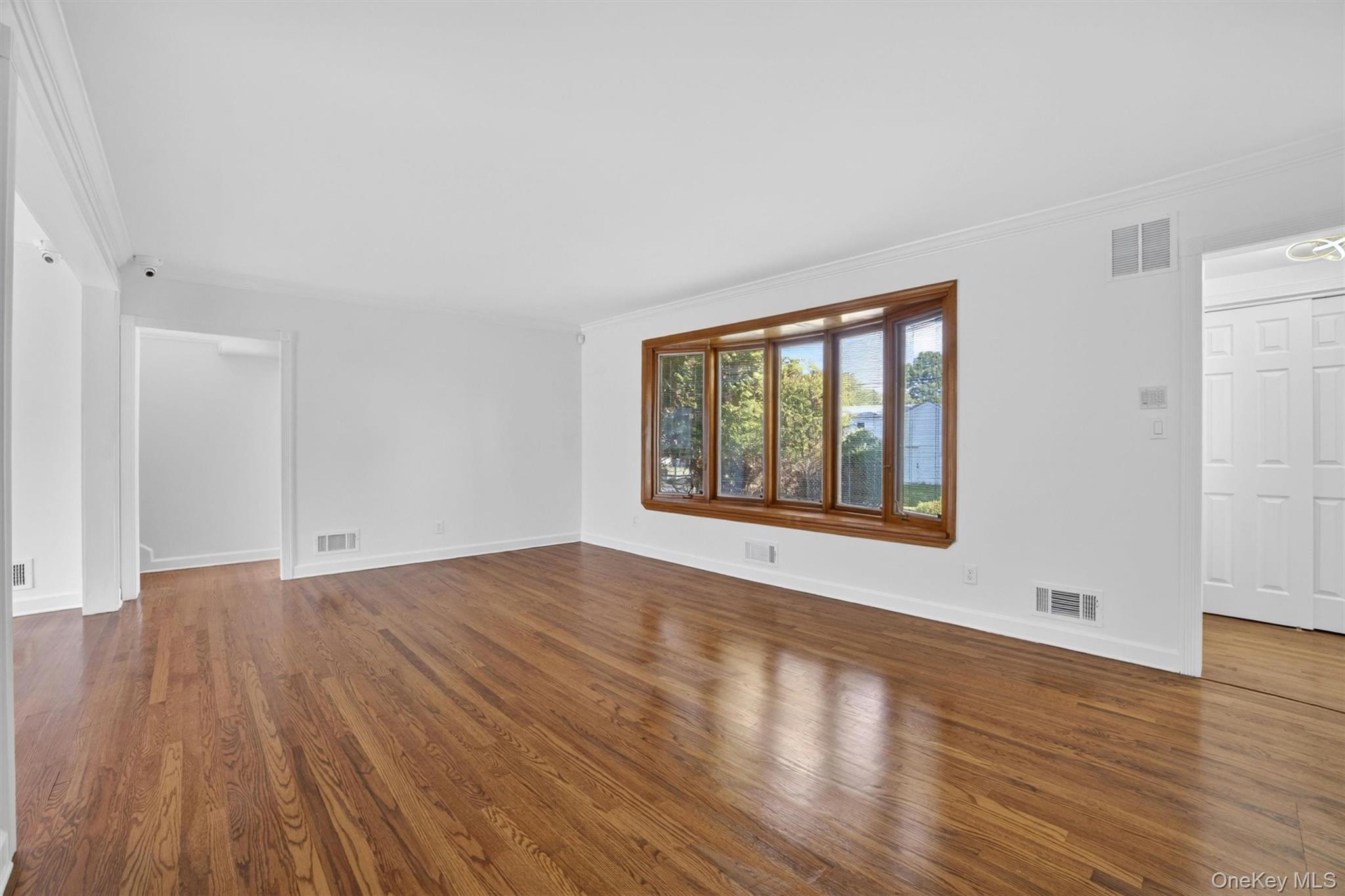 263 Croydon Road Yonkers, NY 10710 - Photo 7 of 43 a view of an empty room with wooden floor and a window