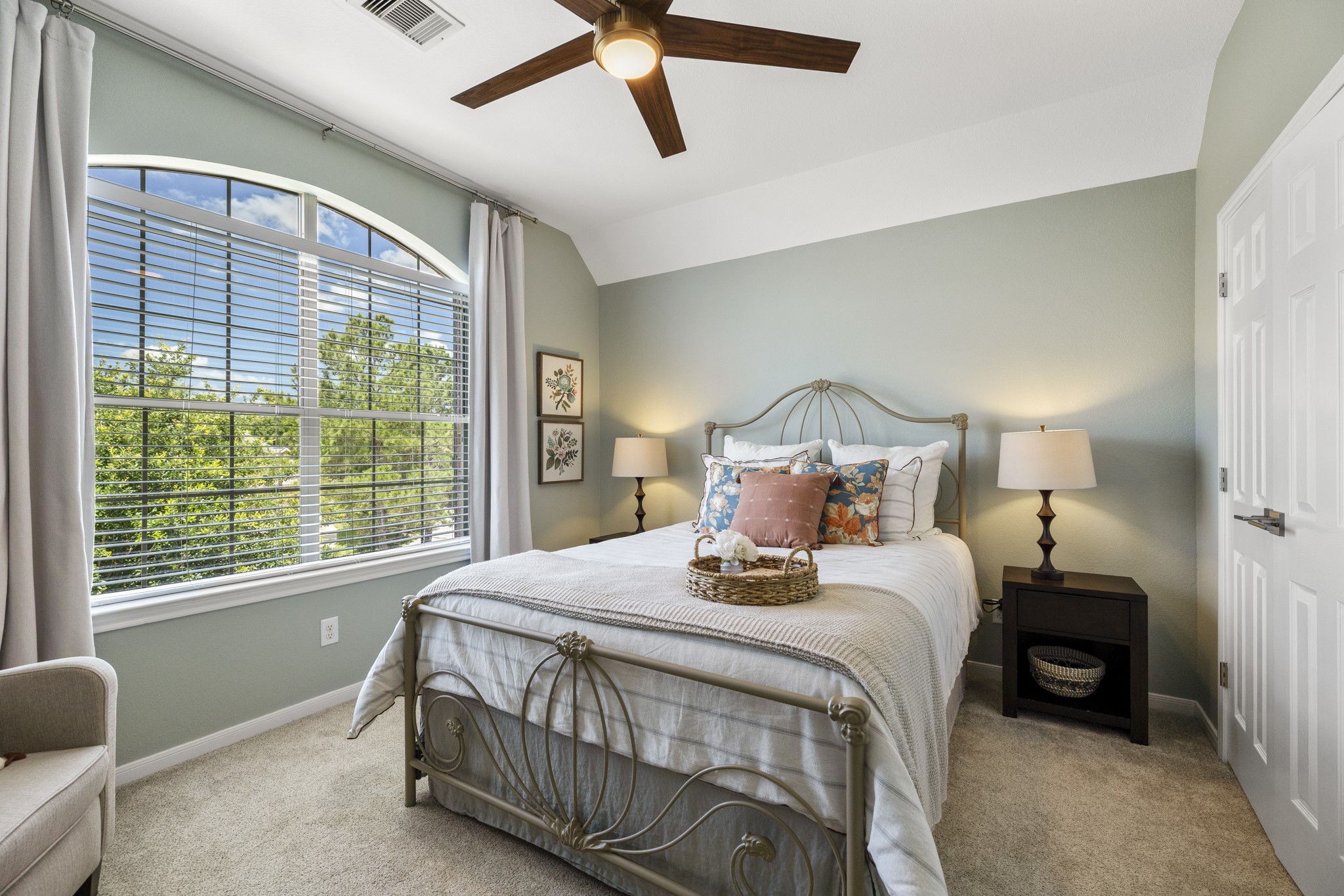 26 Winhall Place The Woodlands, TX 77354 - Photo 29 of 49 a bedroom with a bed a window and lamp