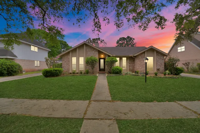 a front view of a house with a garden