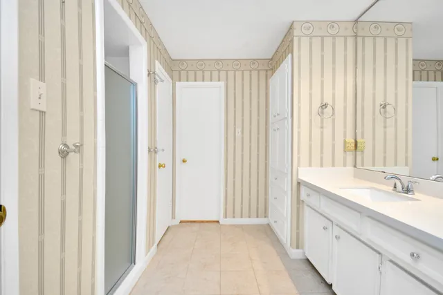 an empty room with a ceiling fan and a window