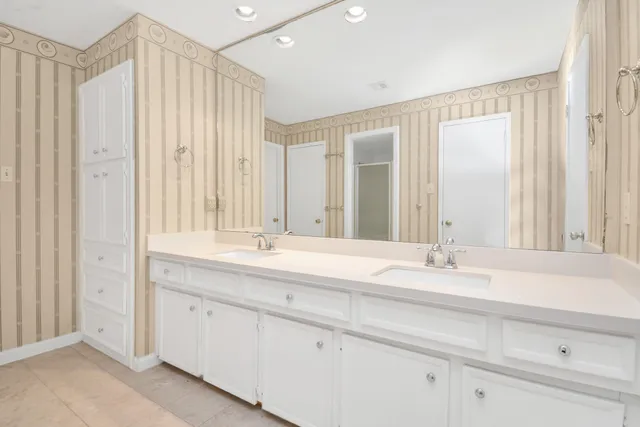 a bathroom with a double vanity sink and a mirror