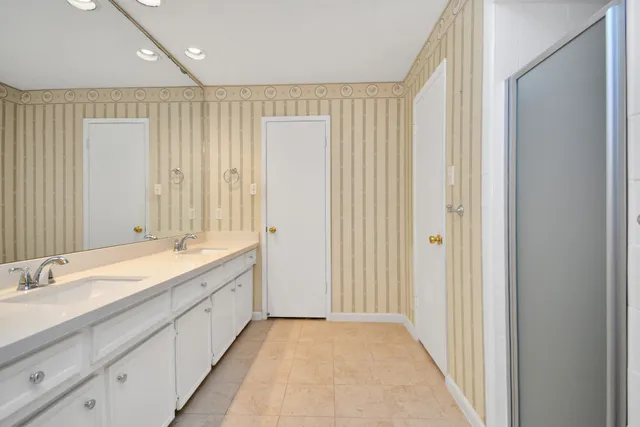 a bathroom with a double vanity sink and a mirror