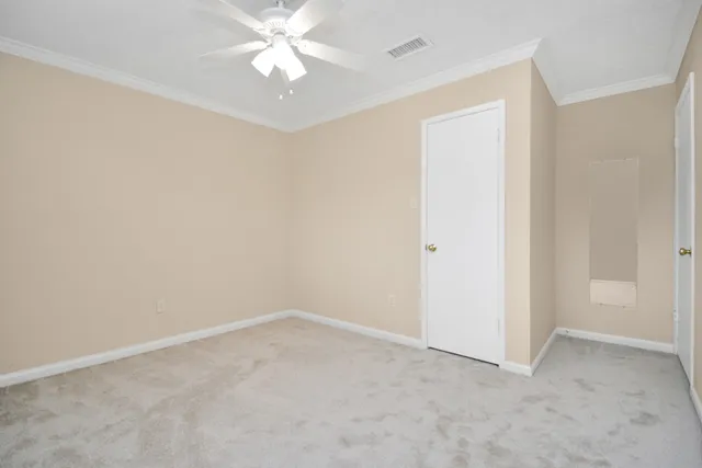 an empty room with a ceiling fan and a window