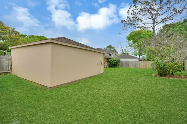 a view of a backyard with a large tree