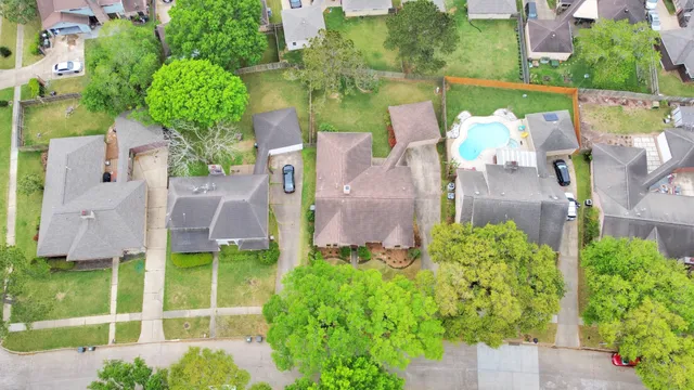 an aerial view of a house with a yard and potted plants