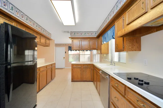 a view of an empty room with chandelier and a window