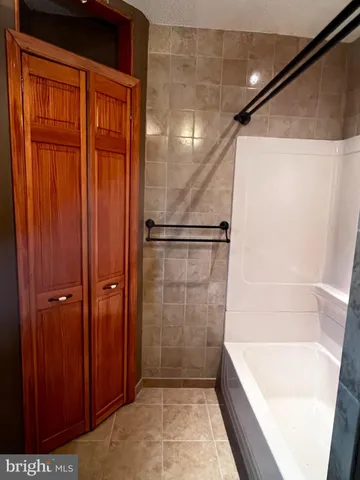 a bathroom with a shower and a tub