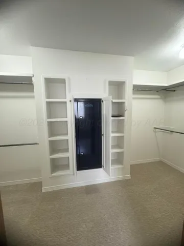 a view of walk in closet with empty racks