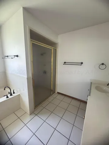 a spacious bathroom with a bathtub and next to a window