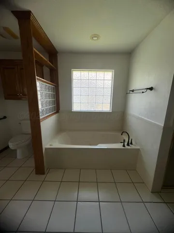 a large bathroom with a double vanity sink a mirror and a bathtub