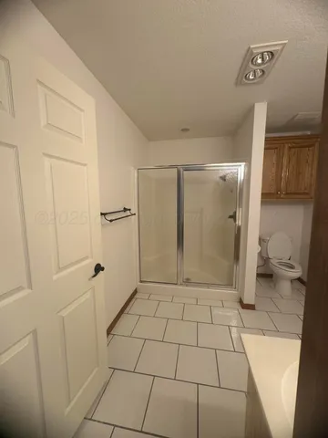 a spacious bathroom with a double vanity sink mirror and bathtub