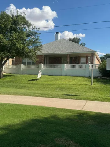a view of a house next to a big yard