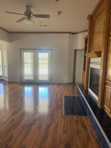 wooden floor in an empty room with a fireplace