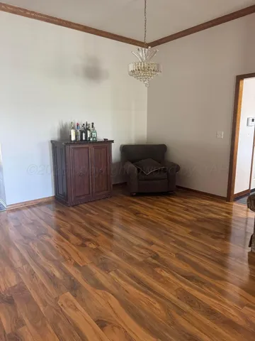 a room with wooden floor and cabinets
