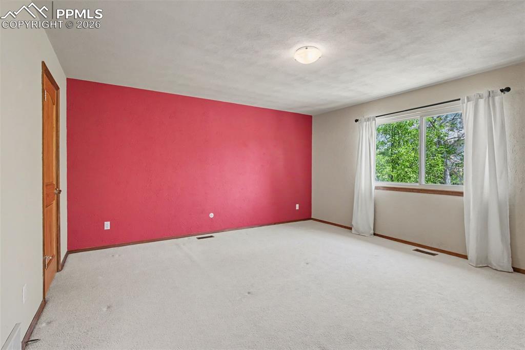 5301 Pinon Valley Road Colorado Springs, CO 80919 - Photo 18 of 27 an empty room with windows and closet