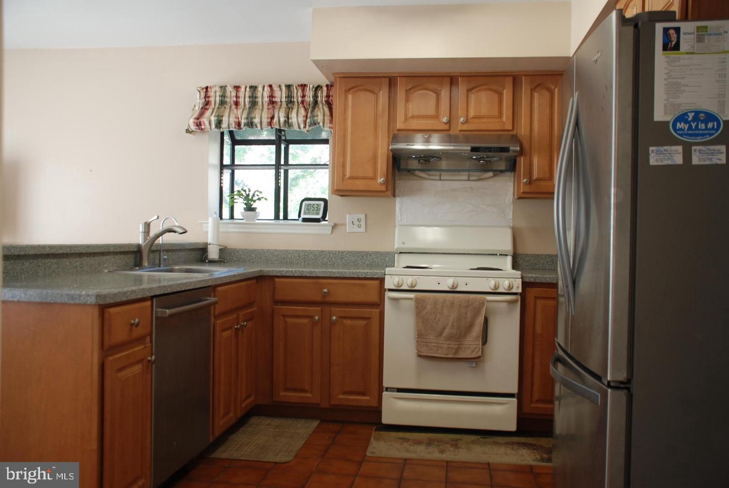 28 Knox Court Chesterbrook, PA 19087 - Photo 8 of 16 a kitchen with stainless steel appliances granite countertop a sink and a stove next to a refrigerator