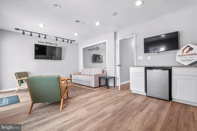 a living room with furniture and a wooden floor