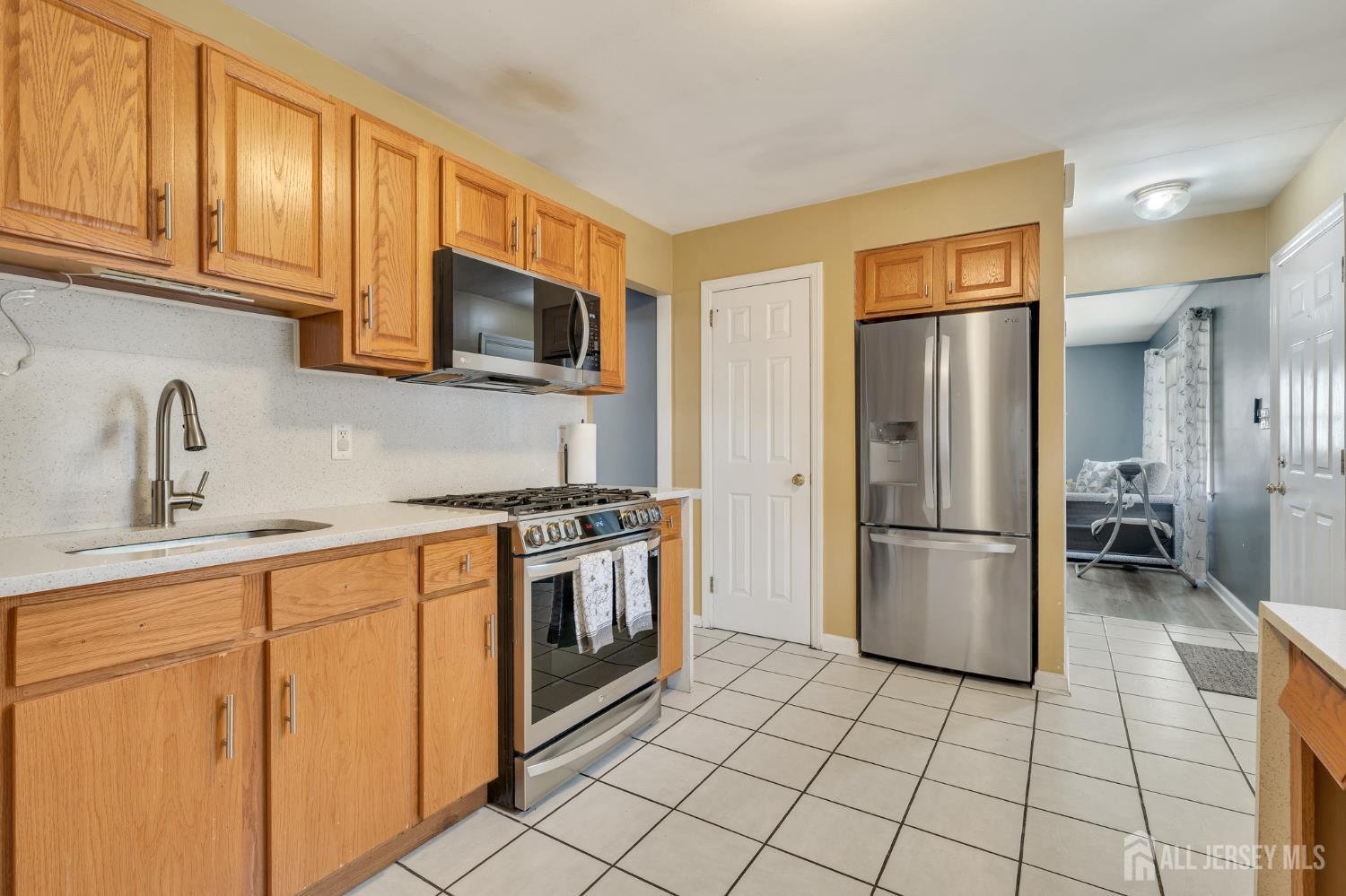 12 Pierrepont Avenue Middlesex, NJ 08846 - Photo 7 of 30 a kitchen with a refrigerator sink and cabinets