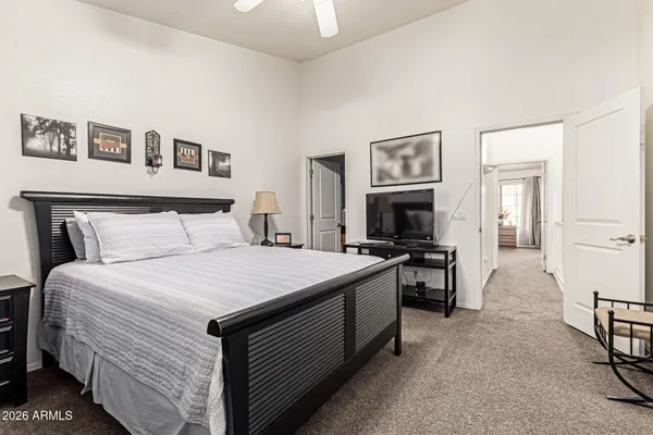 a bedroom with a bed and a television