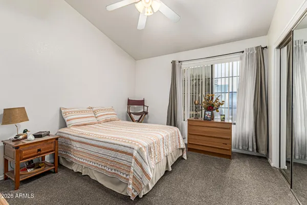 a bedroom with a bed and a window