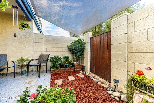a view of a patio with table and chairs and potted plants