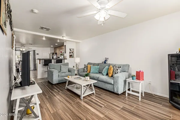 a living room with furniture and a chandelier