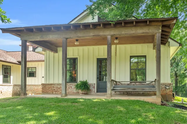 a backyard of a house with table and chairs